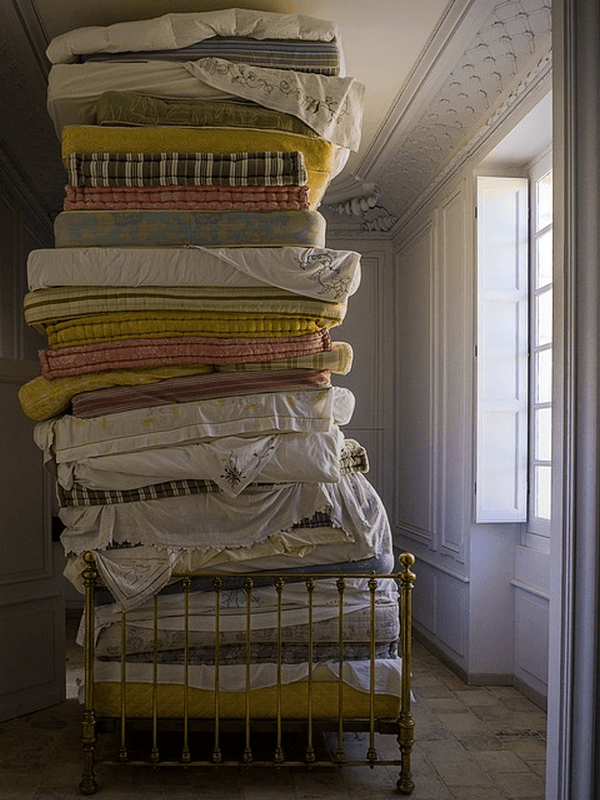 A large stack of old mattresses