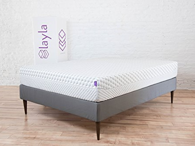Layla Mattress on bed frame next to delivery box