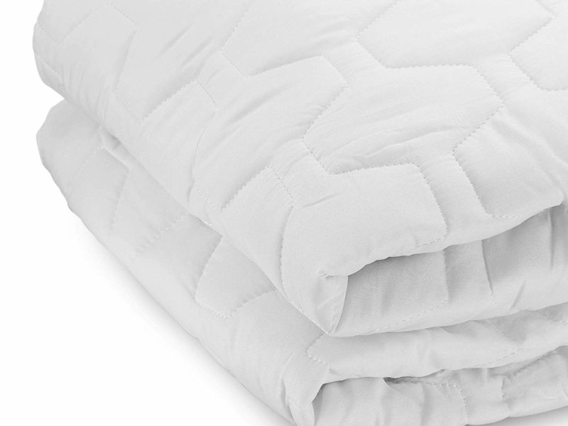 the grand mattress pad against white background