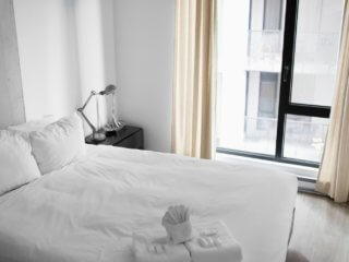 white towels and linens on bed